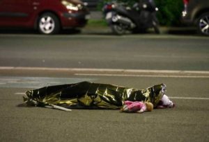 ATTENTION EDITORS - VISUAL COVERAGE OF SCENES OF INJURY OR DEATH - A body is seen on the ground July 15, 2016 after at least 30 people were killed in Nice, France, when a truck ran into a crowd celebrating the Bastille Day national holiday July 14. REUTERS/Eric Gaillard REUTERS/Eric Gaillard