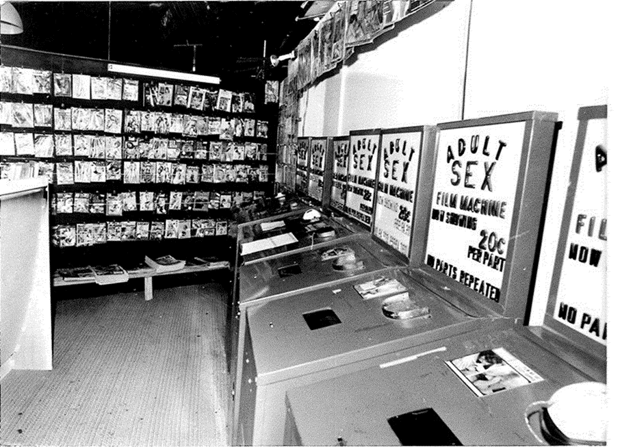 Interior of a Kings Cross sex shop, showing the shelves of porn magazines and coin-operated sex video machines.